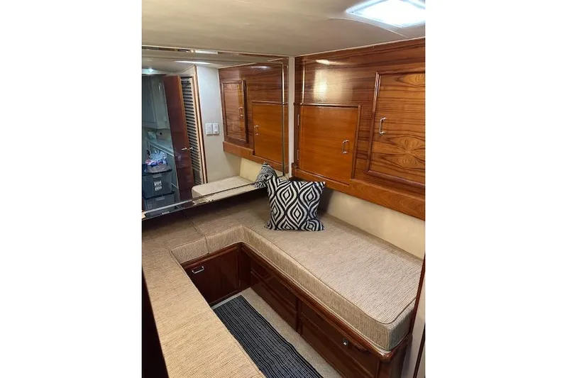 Reel'n In Style Yacht Photos Pics 1988 Ocean 44' Super Sport yacht interior with wooden cabinetry and cushioned seating.
