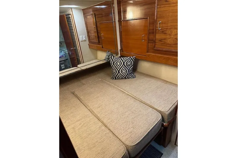 Reel'n In Style Yacht Photos Pics Interior cabin of 1988 Ocean 44' Super Sport yacht with cushioned seating and wooden cabinets.
