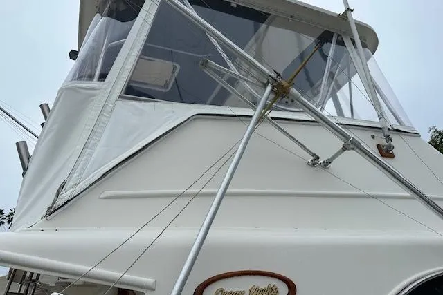 Reel'n In Style Yacht Photos Pics 1988 Ocean 44' Super Sport yacht with white exterior and fishing equipment.