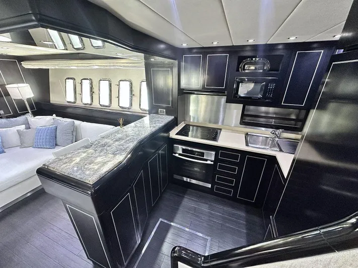 Payback Yacht Photos Pics Luxurious kitchen interior of 2007 Mangusta 80 Motoryacht with modern appliances and sleek design.