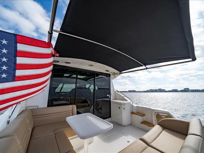  Yacht Photos Pics 2015 Sea Ray 510 Inboard Sundancer yacht with American flag, spacious deck, and ocean view.