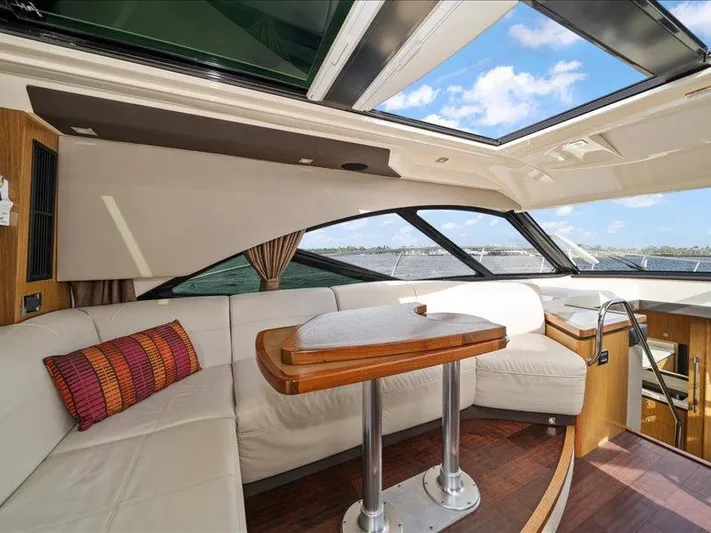  Yacht Photos Pics Luxurious interior of 2015 Sea Ray 510 Inboard Sundancer yacht with elegant seating and table.