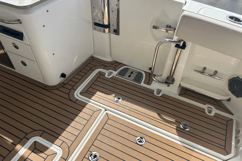  Yacht Photos Pics 2017 Boston Whaler 320 Vantage boat deck with wood finish and storage compartments.