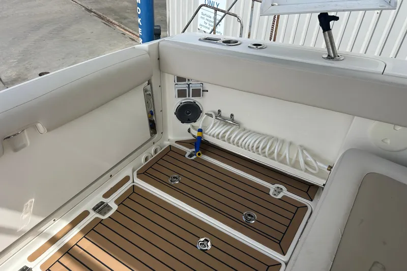  Yacht Photos Pics 2017 Boston Whaler 320 Vantage interior with teak flooring and coiled hose.