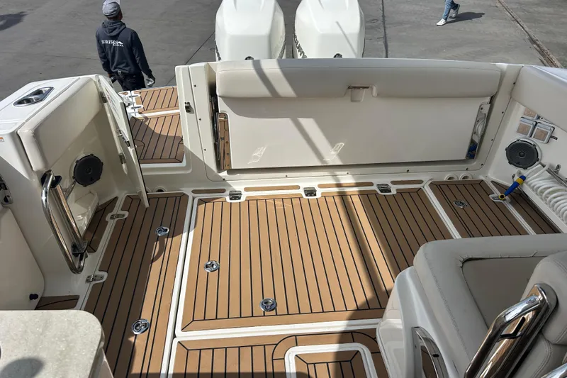  Yacht Photos Pics 2017 Boston Whaler 320 Vantage boat interior with teak flooring and seating area.