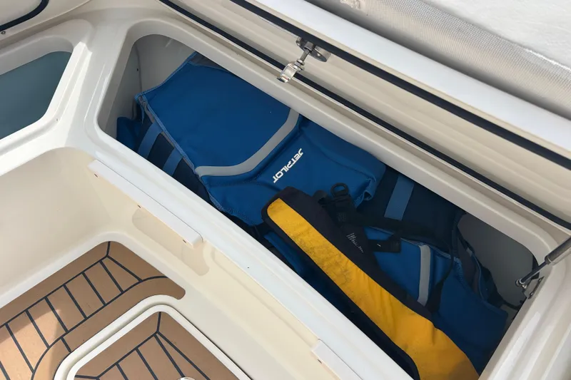  Yacht Photos Pics Storage compartment on 2017 Boston Whaler 320 Vantage with life jackets and gear.
