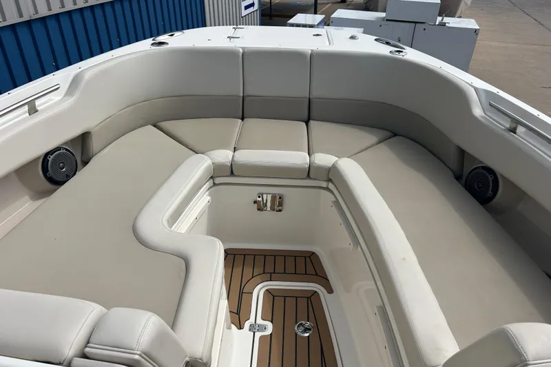  Yacht Photos Pics 2017 Boston Whaler 320 Vantage boat interior with cushioned seating and teak flooring.