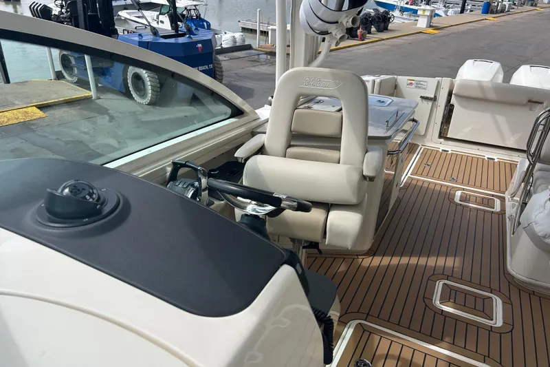  Yacht Photos Pics 2017 Boston Whaler 320 Vantage boat interior with helm and seating area.