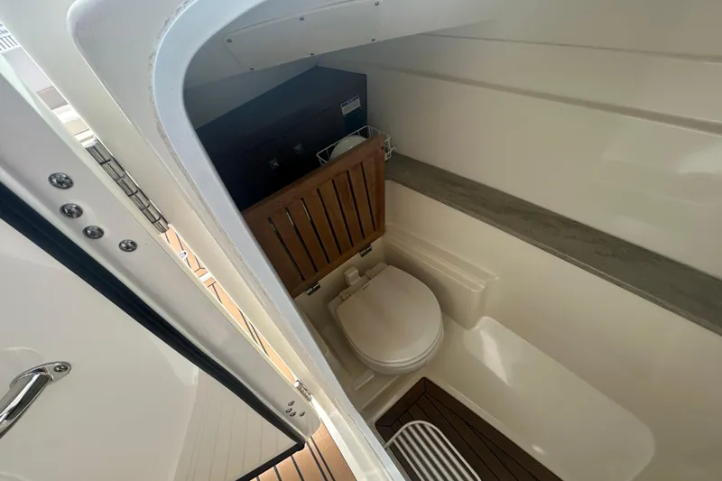  Yacht Photos Pics Interior of 2017 Boston Whaler 320 Vantage boat bathroom with wooden accents.