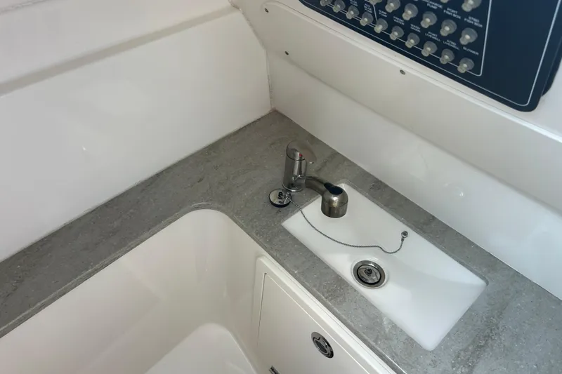  Yacht Photos Pics 2017 Boston Whaler 320 Vantage boat interior with sink and control panel.