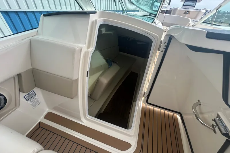  Yacht Photos Pics 2017 Boston Whaler 320 Vantage cabin interior with seating and wood flooring.