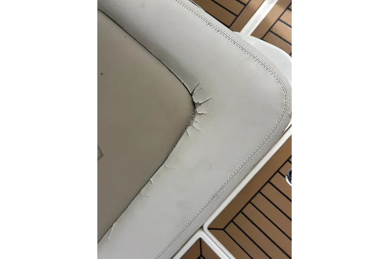  Yacht Photos Pics Cracked seat upholstery on 2017 Boston Whaler 320 Vantage boat, showing wear and tear.