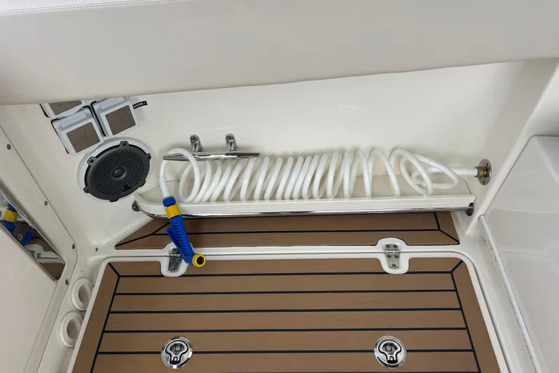  Yacht Photos Pics 2017 Boston Whaler 320 Vantage deck with coiled hose and speaker.