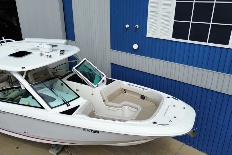  Yacht Photos Pics 2017 Boston Whaler 320 Vantage boat docked near blue building.