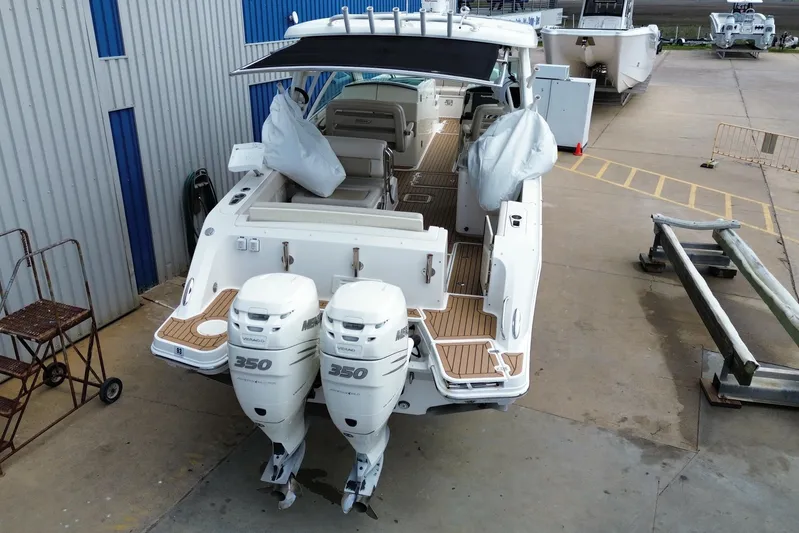  Yacht Photos Pics 2017 Boston Whaler 320 Vantage boat with twin 350 engines, docked at a marina.