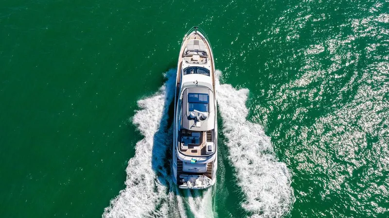Bongani Yacht Photos Pics 2024 Azimut Fly 78 yacht cruising on vibrant green water, aerial view.