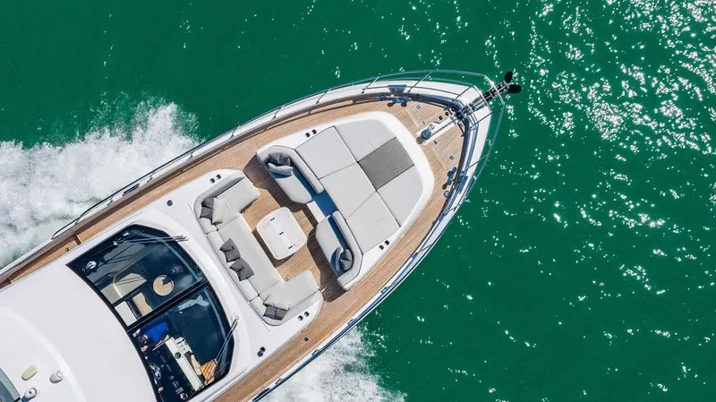 Bongani Yacht Photos Pics 2024 Azimut Fly 78 yacht cruising on turquoise water, aerial view.