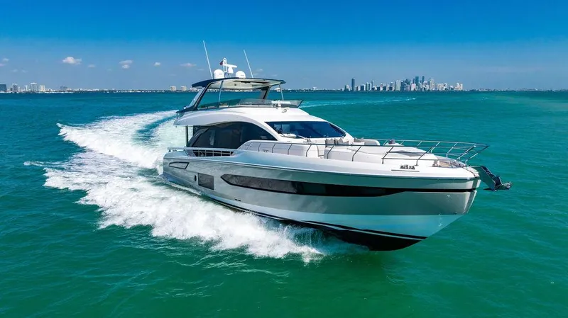Bongani Yacht Photos Pics 2024 Azimut Fly 78 yacht cruising on turquoise waters with city skyline in background.