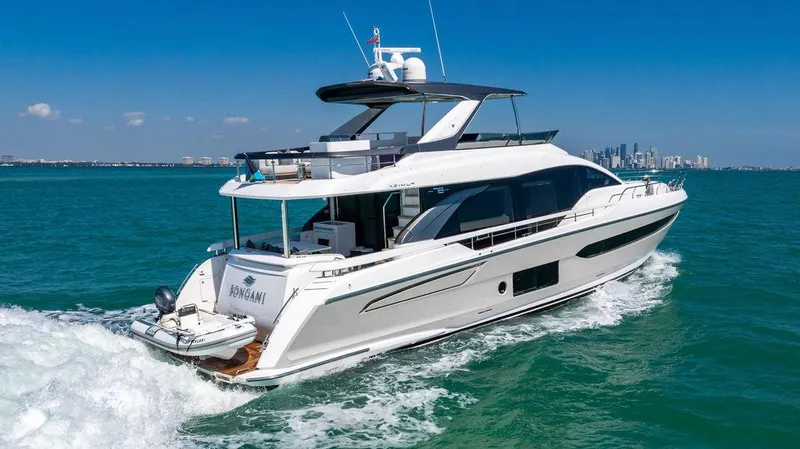 Bongani Yacht Photos Pics 2024 Azimut Fly 78 yacht cruising on open water, city skyline in background.