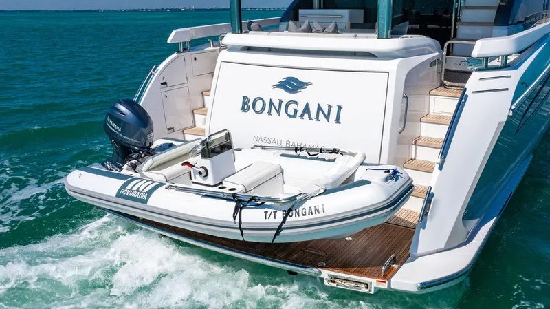 Bongani Yacht Photos Pics 2024 Azimut Fly 78 yacht with tender, cruising in clear blue waters.