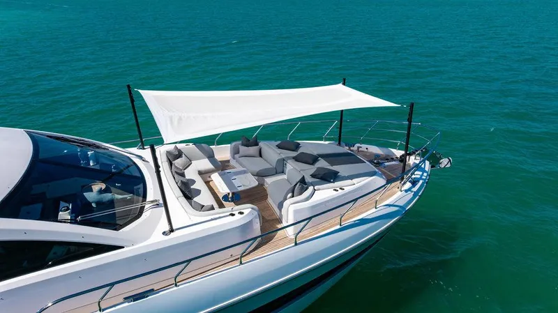 Bongani Yacht Photos Pics Luxurious 2024 Azimut Fly 78 yacht with elegant deck and sunshade on blue water.