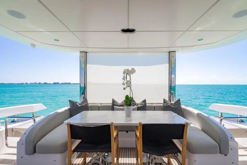 Bongani Yacht Photos Pics Luxurious 2024 Azimut Fly 78 yacht deck with elegant dining area overlooking the ocean.