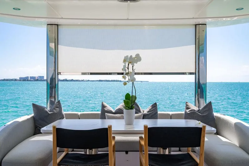 Bongani Yacht Photos Pics Luxurious Azimut Fly 78 yacht interior with ocean view, elegant seating, and decorative orchid, 2024 model.