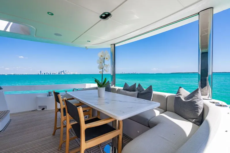 Bongani Yacht Photos Pics Luxurious 2024 Azimut Fly 78 yacht deck with elegant seating, ocean view, and city skyline.