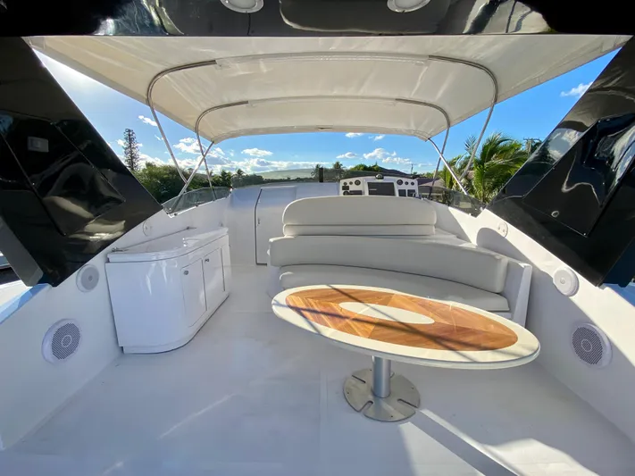  Yacht Photos Pics Luxurious 2007 Rodriquez 80 Widebody yacht deck with seating and table under canopy.