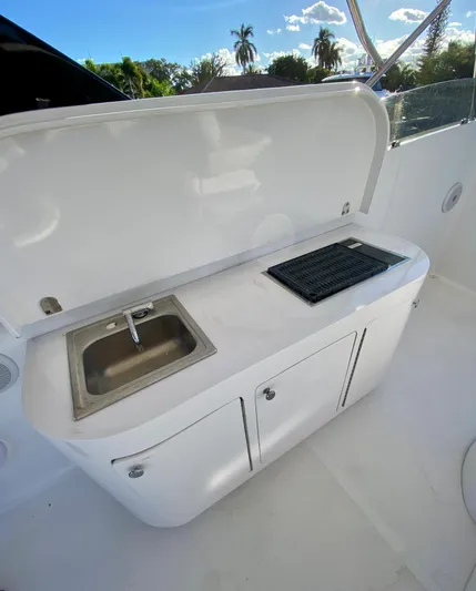 Yacht Photos Pics 2007 Rodriquez 80 Widebody yacht kitchenette with sink and grill, outdoor setting.