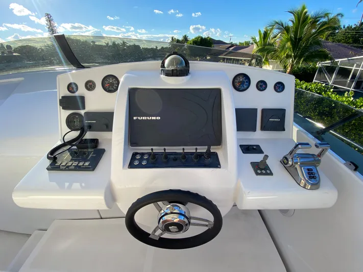  Yacht Photos Pics Helm of 2007 Rodriquez 80 Widebody yacht with navigation controls and steering wheel.