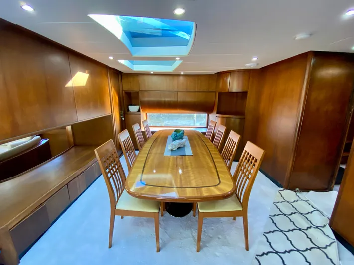  Yacht Photos Pics Luxurious dining area on 2007 Rodriquez 80 Widebody yacht with wooden table and skylight.