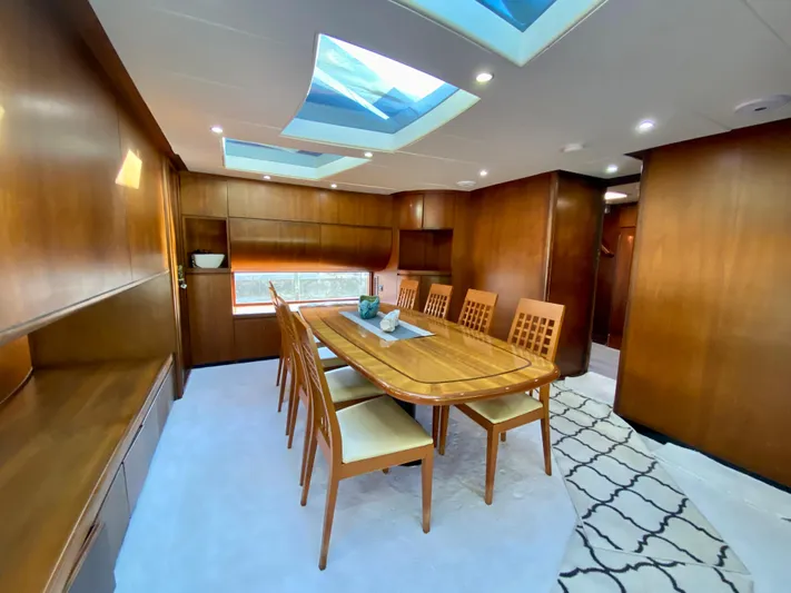  Yacht Photos Pics Luxurious dining area in 2007 Rodriquez 80 Widebody yacht with skylights and wooden furnishings.