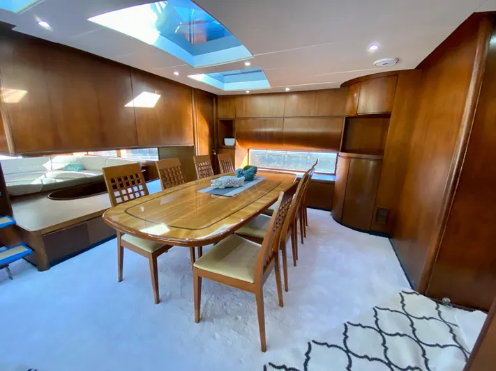  Yacht Photos Pics Luxurious dining area in a 2007 Rodriquez 80 Widebody yacht with wooden interiors.