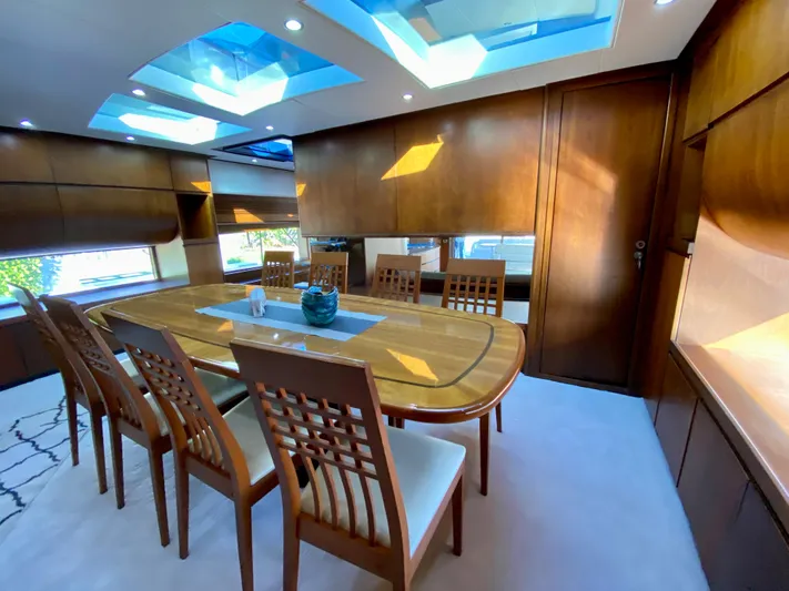  Yacht Photos Pics Luxurious dining area in a 2007 Rodriquez 80 Widebody yacht with skylights and wooden decor.