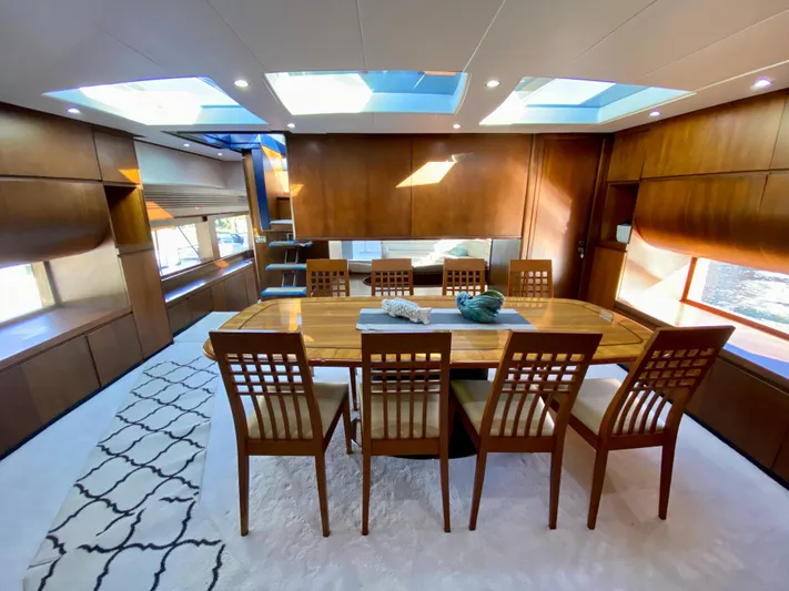 Yacht Photos Pics Luxurious dining area on 2007 Rodriquez 80 Widebody yacht with skylights and elegant wood finishes.