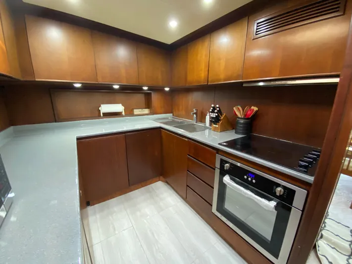  Yacht Photos Pics Luxurious kitchen in 2007 Rodriquez 80 Widebody yacht with modern appliances and wood cabinetry.