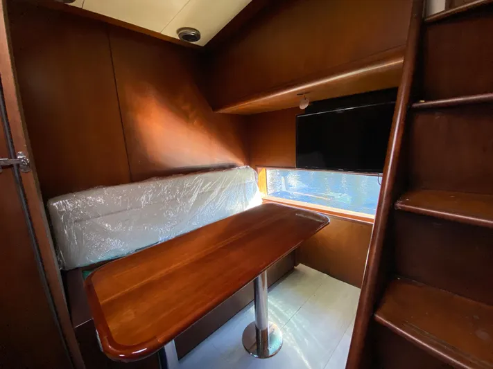  Yacht Photos Pics Cozy interior of 2007 Rodriquez 80 Widebody yacht with wooden table and seating.