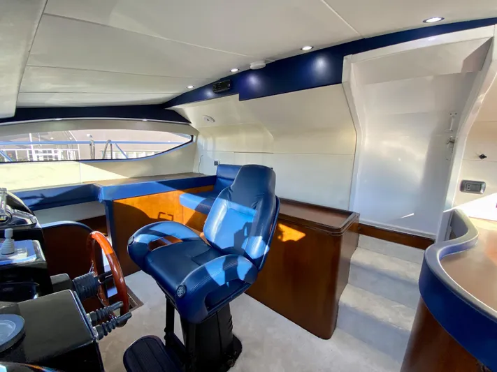 Yacht Photos Pics Luxurious interior of 2007 Rodriquez 80 Widebody yacht with blue captain's chair and modern helm.