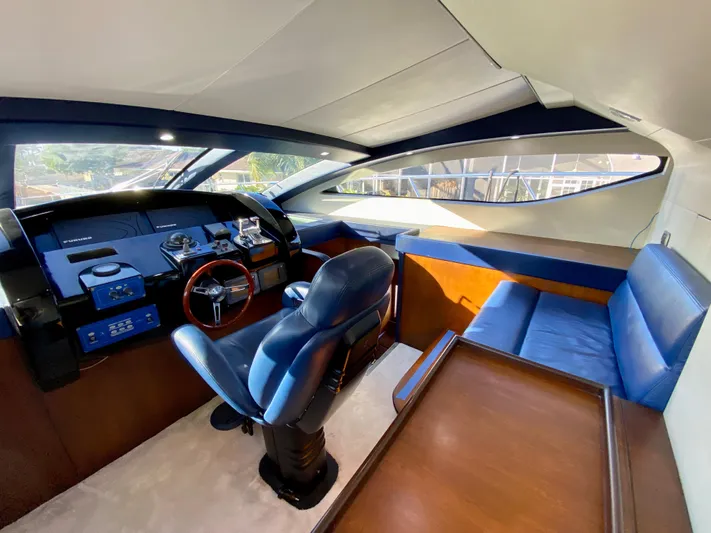  Yacht Photos Pics Interior of 2007 Rodriquez 80 Widebody yacht with blue seating and modern helm.