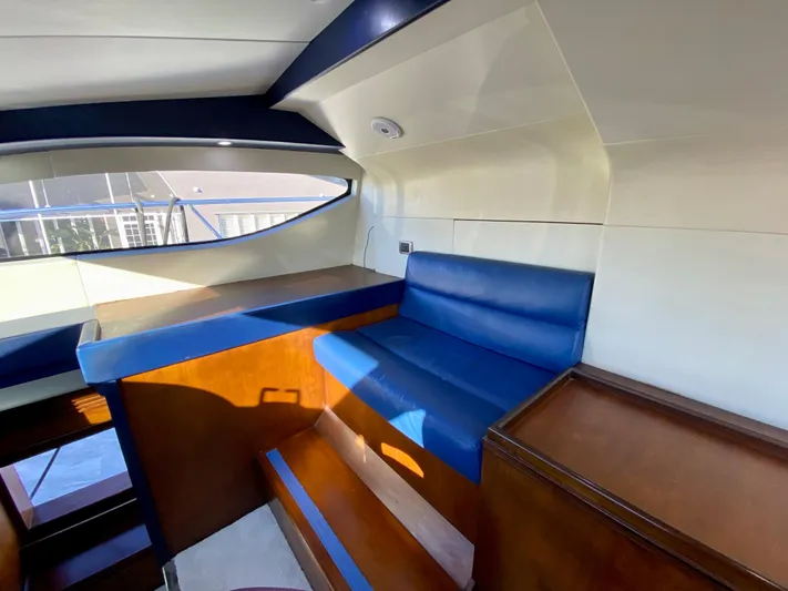  Yacht Photos Pics Interior of 2007 Rodriquez 80 Widebody yacht with blue seating and wooden accents.