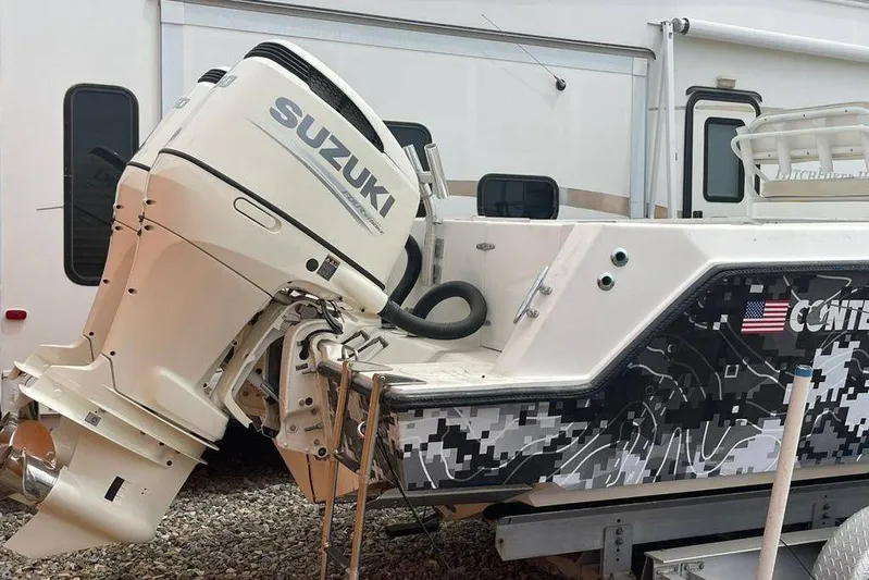  Yacht Photos Pics 2001 Contender 27 Open CC boat with Suzuki outboard motor, digital camouflage design.