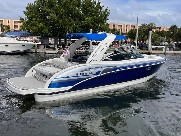  Yacht Photos Pics 2020 Formula 310 Bowrider boat in marina, featuring sleek blue and white design.