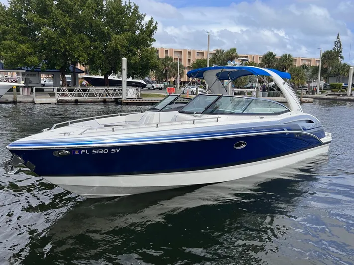  Yacht Photos Pics 2020 Formula 310 Bowrider boat on water, blue and white design, docked at marina.