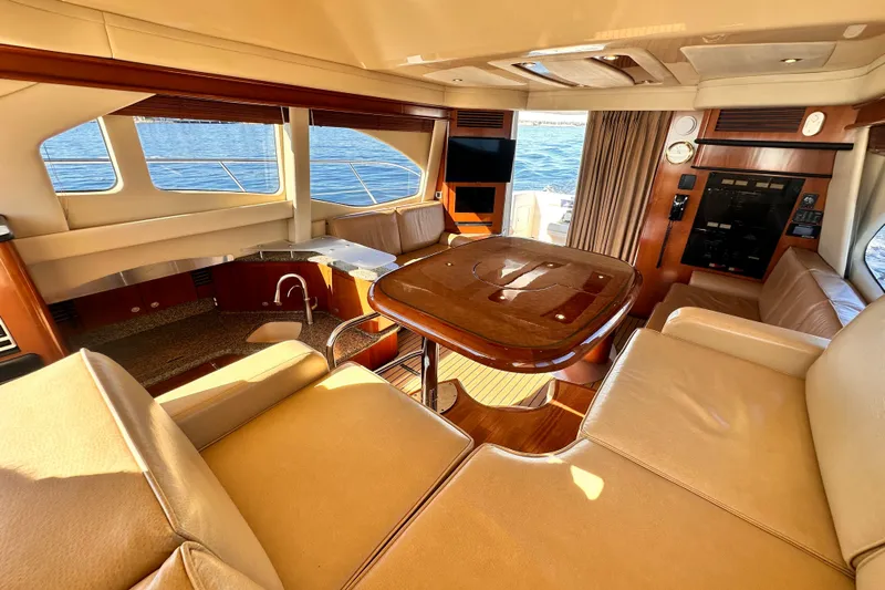 Lanakilla Yacht Photos Pics Luxurious interior of 2005 Sea Ray 420 Sedan Bridge yacht with elegant seating and ocean view.
