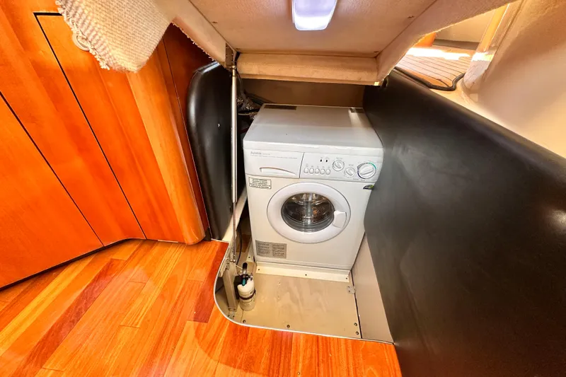 Lanakilla Yacht Photos Pics Washing machine in 2005 Sea Ray 420 Sedan Bridge yacht interior with wooden flooring.