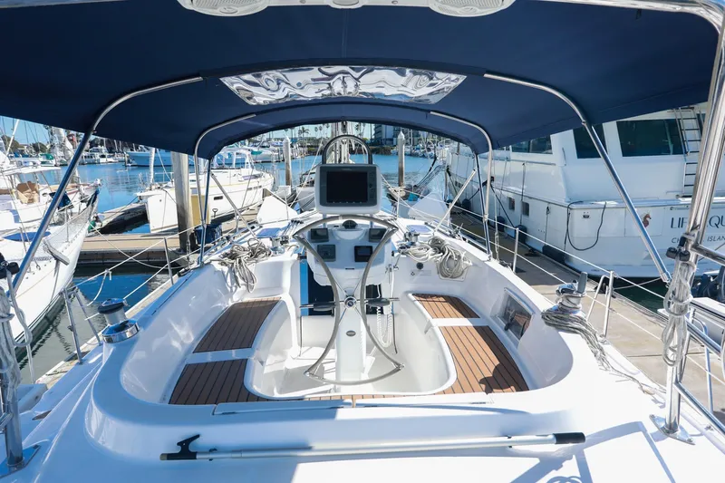 Matt's Dinghy Yacht Photos Pics 2009 Hunter 45 Center Cockpit sailboat with modern helm, docked in marina.