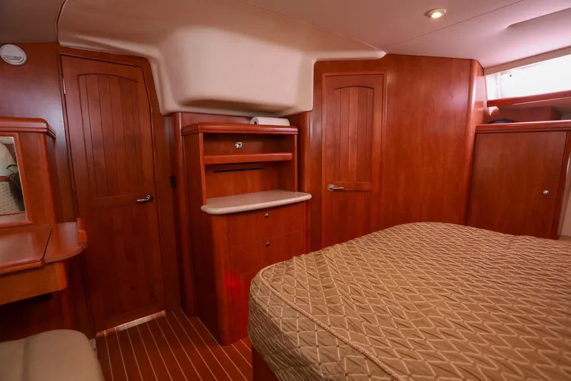 Matt's Dinghy Yacht Photos Pics Luxurious 2009 Hunter 45 Center Cockpit interior with wood finish and cozy bedding.