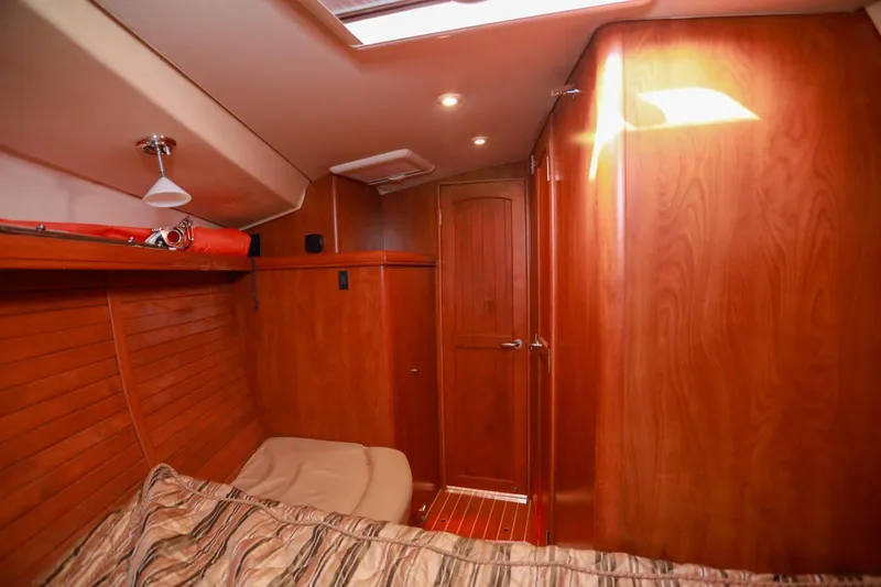 Matt's Dinghy Yacht Photos Pics Interior of 2009 Hunter 45 Center Cockpit yacht with wooden paneling and cozy cabin.