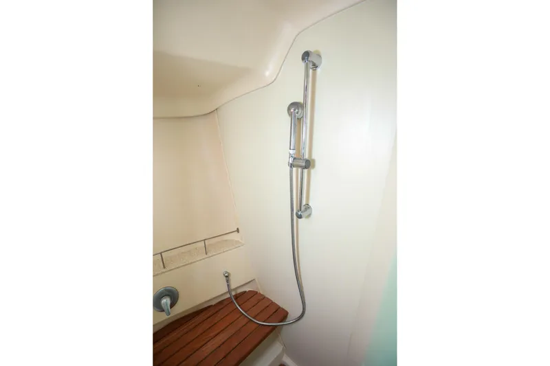 Matt's Dinghy Yacht Photos Pics Shower area in 2009 Hunter 45 Center Cockpit yacht with wooden seat and adjustable showerhead.
